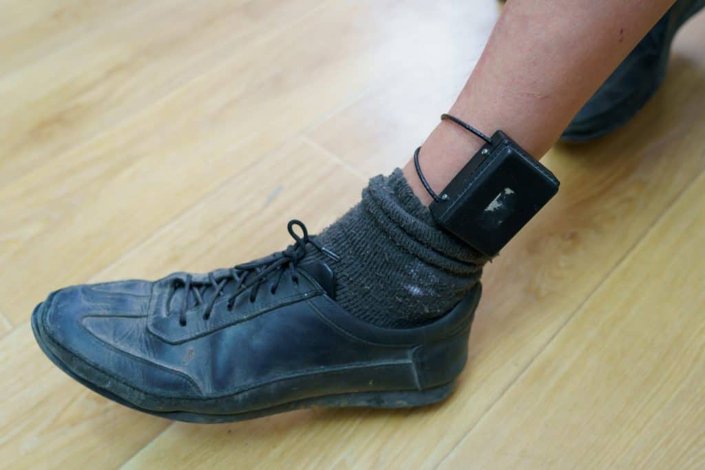 Amazon associate wearing ankle monitor